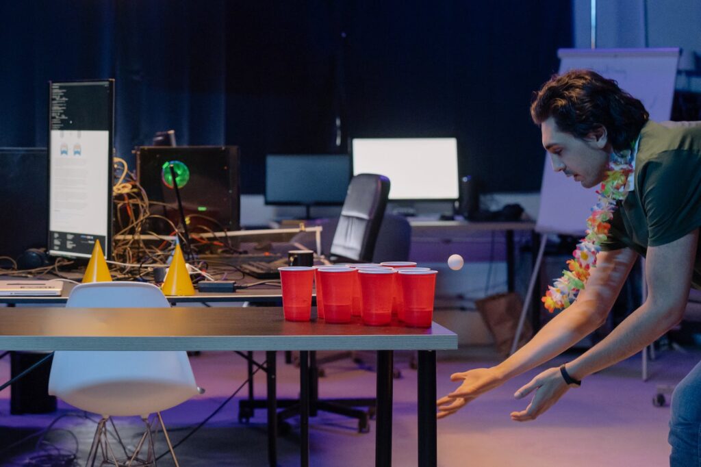 a man with floral lei playing parlor games